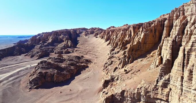 Scenic view of rugged Yardang geological formations and wind-eroded rocks in the Gobi Desert, Xinjiang, China.