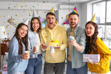 Group of young friends with cake and gift celebrating Birthday at party © Pixel-Shot