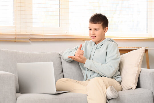 Mute boy using sign language during video call at home