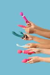 Obraz premium Women with vibrators on blue background