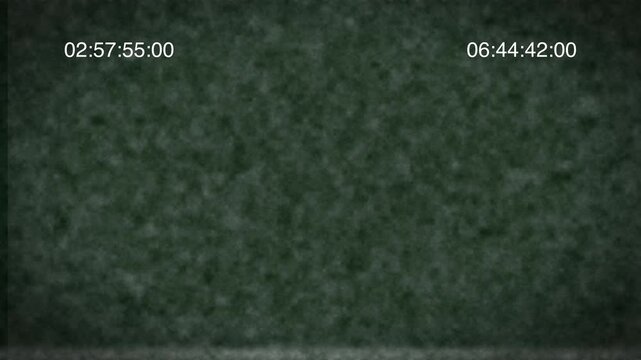 A dark green textured surface with time codes displayed in 4K resolution from a top-down viewpoint
