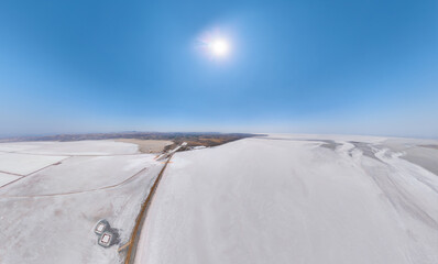 Aksaray, Turkey. Expansive aerial panorama of dried white Tuz Golu salt flats crossed by dark brown...