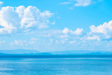 Tropical Nature clear sky and summer sea water under a clear blue sky with beautiful clouds and bright sunlight. Perfect for summer vacation and travel background	
