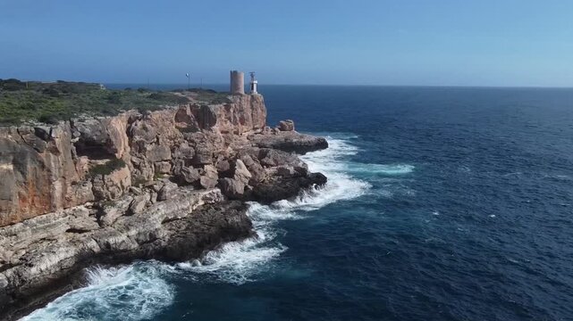 Torre d'en Beu lighthouse next to Cala Figuera on a sunny winter day, Mallorca, Spain