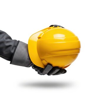 A person holding a bright yellow construction helmet with a black strap. isolated on white background