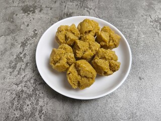 Traditional Indonesian Apem Cake With Palm Sugar and Grated Coconut in White Plate