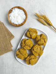 Traditional Indonesian Apem Cake With Palm Sugar and Grated Coconut in White Plate