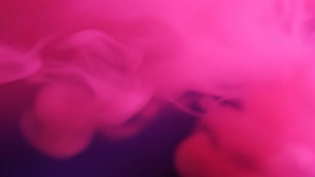 Vibrant pink smoke or ink dissolving in water creating an abstract background