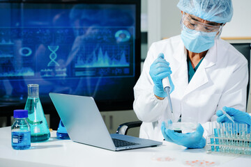 Scientists performing DNA genome analysis using digital tablet interface in biotechnology laboratory for medical research, genetics, pharmaceutical innovation and AI diagnostics. © Nuttapong punna