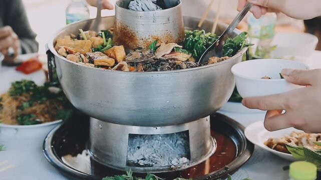 Shabu Shabu or Sukiyaki or hot pot ,Hand holding pork using chopsticks, Japanese food in restaurant