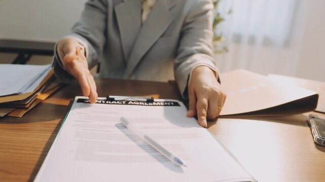 Justice and law concept. Gavel on sounding block in hand's Male judge at a courtroom, working with document law books, report the case on table in modern office.