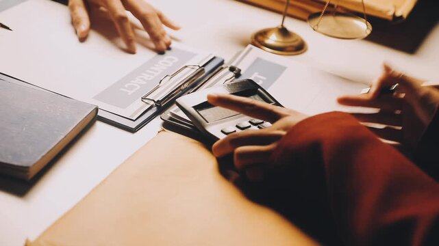 Justice and law concept. Gavel on sounding block in hand's Male judge at a courtroom, working with document law books, report the case on table in modern office.