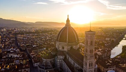 Fototapeta premium Aerial view of a historic city at sunset with a large cathedral