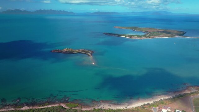 Horseshoe Bay Bowen Australia aerial drone ocean view nature landscape Airlie Beach Proserpine sunny blue sky Coral Sea Marina Harbor View Great Barrier Reef Whitsunday Region backwards pan up motion