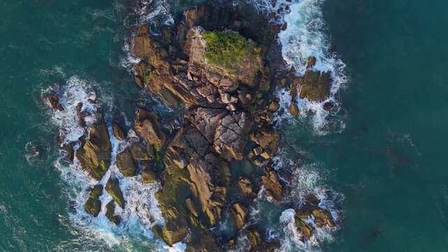Aerial view of the stone bridge and walkway at Arma&ccedil;&atilde;o Beach in Florianopolis. Tourists walking towards the Matadeiro trail at sunrise.