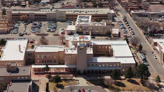 The camera reverses from the unique circular State Capitol to reveal the surrounding architecture of downtown Santa Fe. This 4K shot highlights the heart of New Mexico's government.