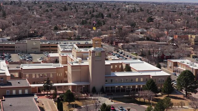 Capture a steady orbital flight of the iconic Southwestern capitol building. This 4K vista emphasizes the monumental scale of the facility in the urban center.