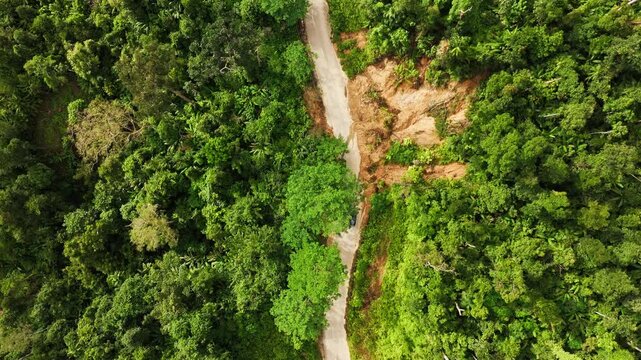 Drone aerial showing landslide cutting off mountain road after typhoon