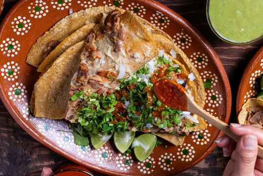 Delicious Carnitas Street Style Taco with Fresh Toppings on Clay Plate Cuisine. Gringa