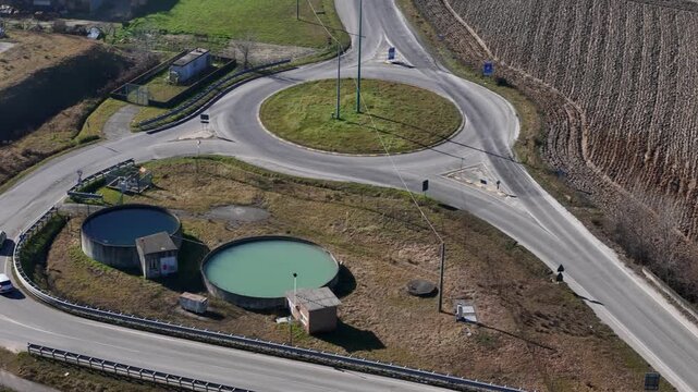 Road roundabout connecting SP21 and SP4 with water treatment basins in rural landscape near Lugagnano Val d&rsquo;Arda, Province of Piacenza, Emilia Romagna, Italy connecting Morfasso, Vernasca
