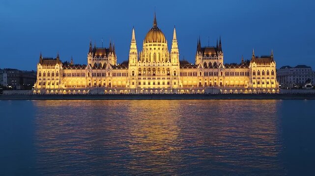 Luminous hungarian parliament building majestically reflecting on the danube river at dusk