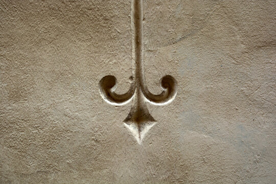 Carved pattern on old stone wall, background with ancient texture, vintage relief.