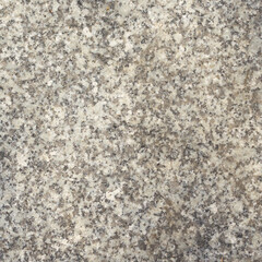 Tekstura szarego granitu, naturalna powierzchnia kamienia z drobnym ziarnem i plamkami, tło do projektów i architektury. © Henryk Guziak