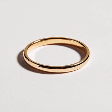 Golden band ring on white background; top-down view; simple elegance