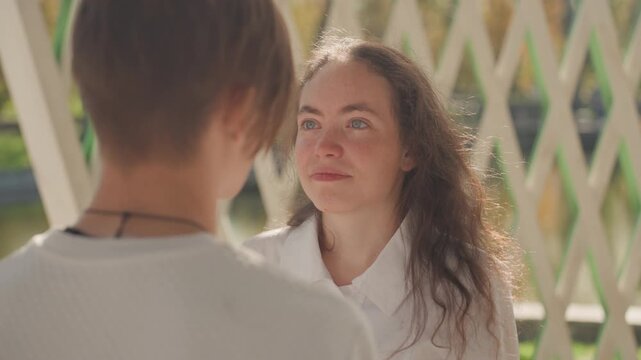 Couples promise devotion beneath shining sunlight. Romantic mates pledge eternal love during bright sunlit event. Lovers forge lifelong commitments as sunlight bathes their heartfelt vows in warmth