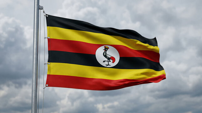 Ugandan national flag proudly waving in the wind on a flagpole.