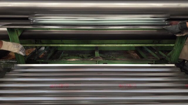 Corrugated zinc sheets are manufactured using large machinery.