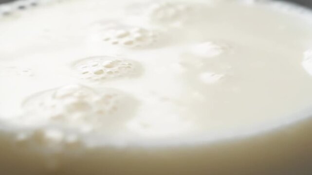 Ultra realistic macro video of kumis liquid texture close-up slow rotating camera fermented drink