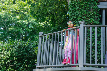 Confident young girl dressed as a super power princess