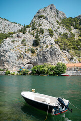 Fototapeta premium Omis Croatia Cetina River boat and tunnel carved into rocky mountain