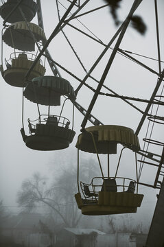 An old amusement park in thick fog in the middle of the park, in