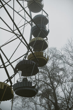 An old amusement park in thick fog in the middle of the park, in