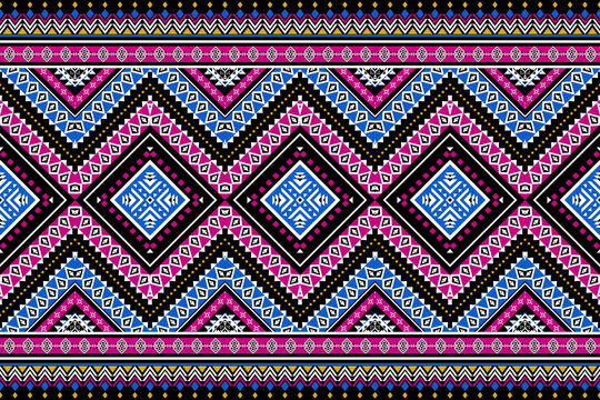 Seamless geometric ethnic pattern with colorful zigzag stripes, diamond motifs and tribal ornament elements. Inspired by boho and aztec textile design, perfect for fabric, wallpaper, fashion print 