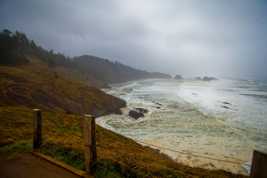 Indian Cove, Oregon Coast, the curving coastline and stormy seas breaking on shore.