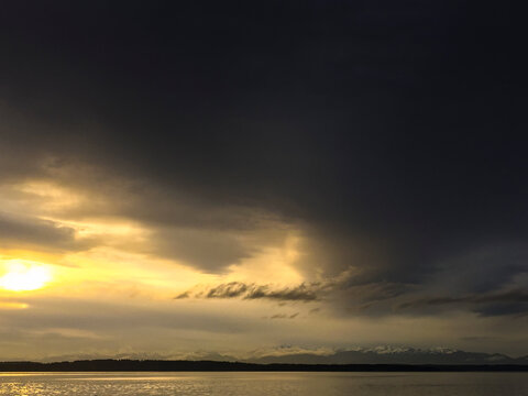 Clearing storm over Puget Sound, clouds making way for sunshine.