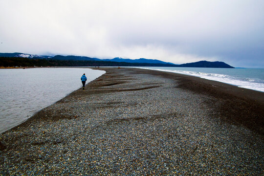 Elwha River estuary at Port Angeles, people walking along the shingle strand.
