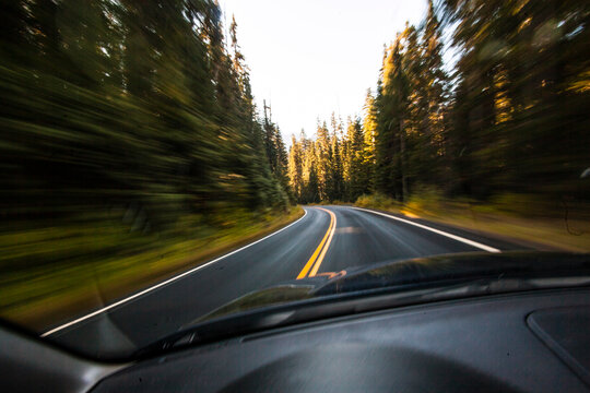 Driver's pov through windshield speeding down two lane highway, Mount Rainier National Park.