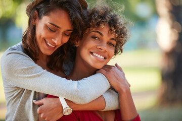 Lesbian, smile or women in park with hug, commitment or bonding together on weekend break. Bokeh, portrait or couple in nature with embrace, LGBTQ connection or healthy relationship on outdoor date.