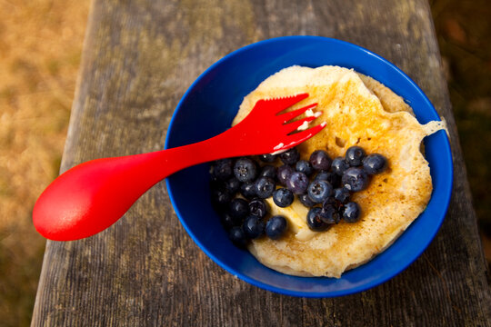 Backpacker's breakfast, Blake Island, a plastic plate and fork, eggs and blueberries.