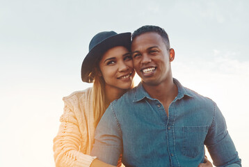 Obraz premium Happy, sunshine and couple outdoor with hug for bonding on holiday, vacation and getaway. Blue sky, travel and man with woman with smile, embrace and affection for relationship, love and connection