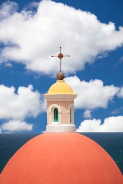 Close-up of the vibrant red dome and yellow cupola of the neoclassical rotunda at Cementerio de Santa Maria Magdalena de Pazzis in Old San Juan
