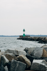 Iconic Lighthouse Standing on a Rugged Coastline, Maritime Sentinel Overlooking the Ocean in Bright Natural Daylight
