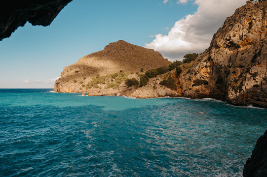 View from rock tunnel over turquoise bay, Sa Calobra Mallorca