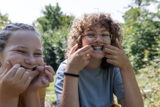 Girls pulling faces on a forest walk in nature