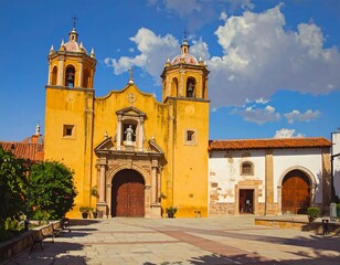 Fototapeta premium A large yellow church with two towers and a courtyard