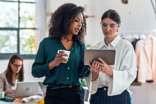 Two colleagues discussing deadline and work pressure in office